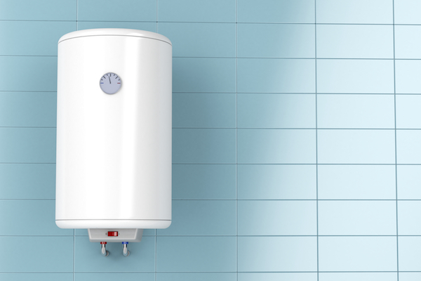 Brand new a white home water heater appliance inside the bathroom of a house. 