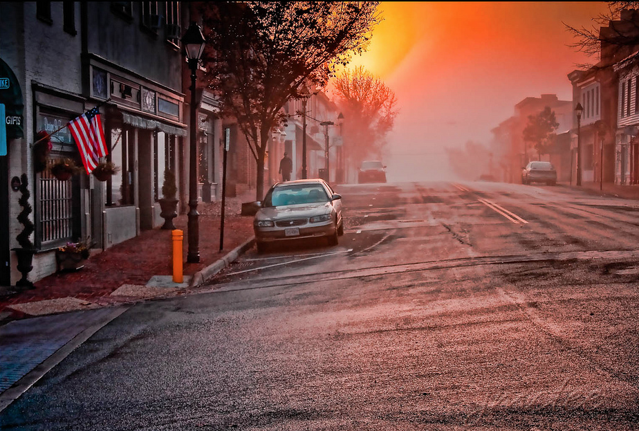Empty street in downtown Warrenton, Virginia with the sun rising in the background. 